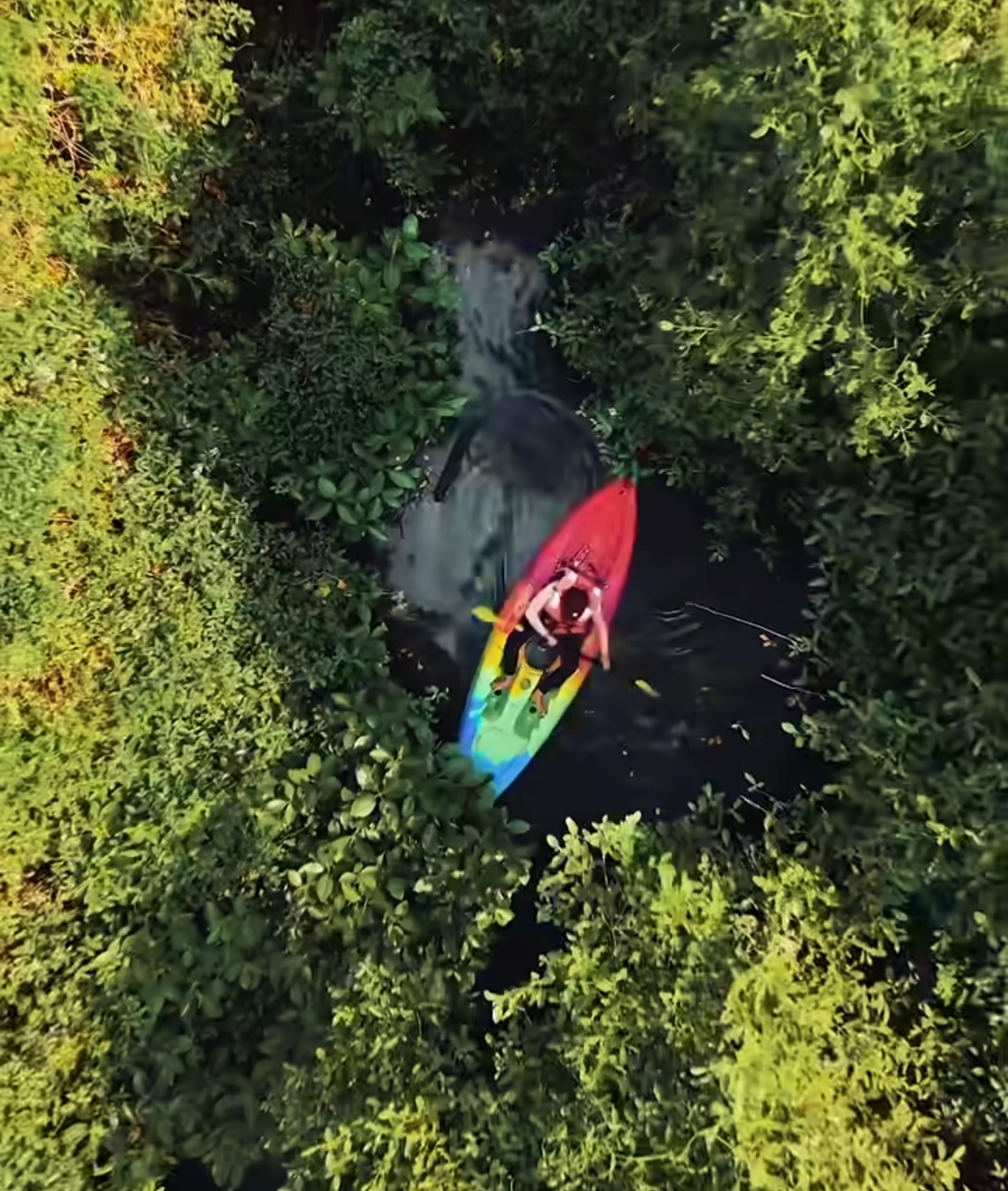 Tourists experiencing kayaking Alleppey in the narrow backwater canals
